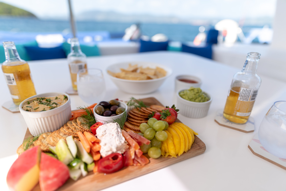 A charcuterie board with the ocean in the background