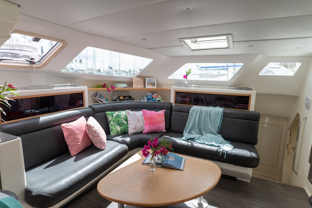 The boat's lounge area including a couch with pillows